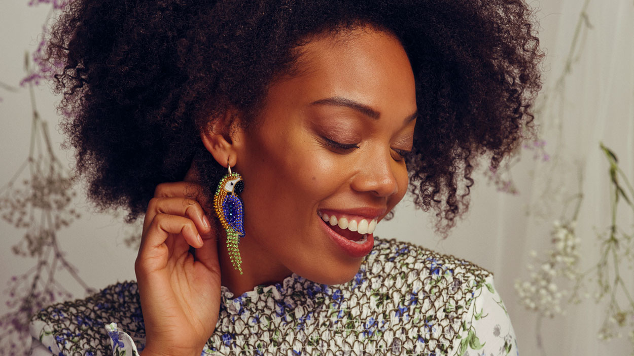 Woman wearing parrot earring from Miccy’s Jewels