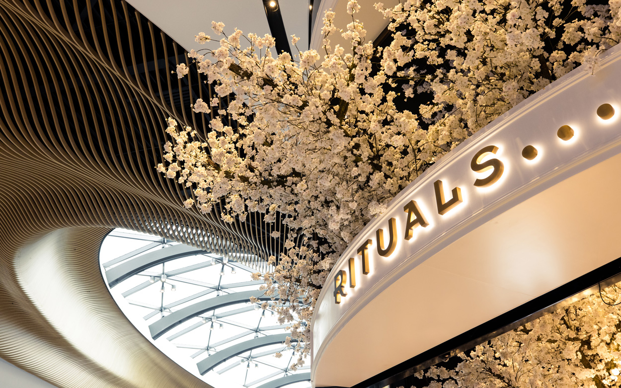 Rituals beauty shop exterior signage and blossom tree